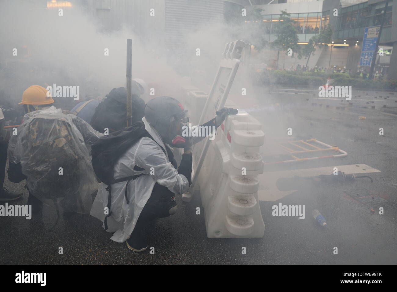Hong Kong, China. 25th Aug, 2019. 25th August 2019. Hong Kong Anti Extradition Bill protest march in Tsuen Wan and Kwai Tsing. After a peaceful march major clashes took place, with protesters 5th throwing bricks, bottles and molotovs at police lines who were firing constant tear gas, rubber bullets and pepper balls. Police also fired live rounds at one point. Protesters dispersed once police mobilized 2 water cannon vehicles. Credit: David Coulson/Alamy Live News Stock Photo