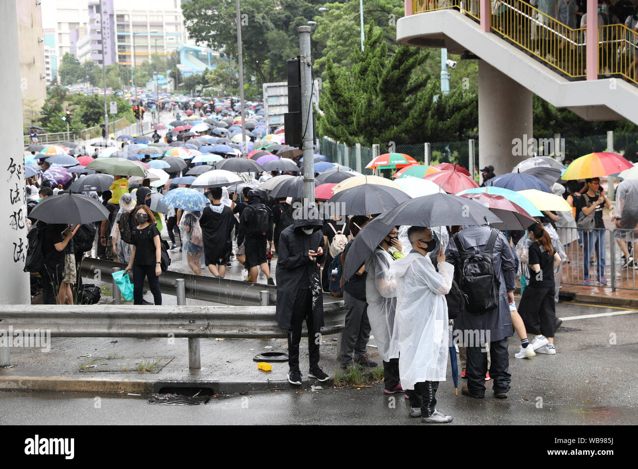 Hong Kong, China. 25th Aug, 2019. 25th August 2019. Hong Kong Anti Extradition Bill protest march in Tsuen Wan and Kwai Tsing. After a peaceful march major clashes took place, with protesters 5th throwing bricks, bottles and molotovs at police lines who were firing constant tear gas, rubber bullets and pepper balls. Police also fired live rounds at one point. Protesters dispersed once police mobilized 2 water cannon vehicles. Credit: David Coulson/Alamy Live News Stock Photo