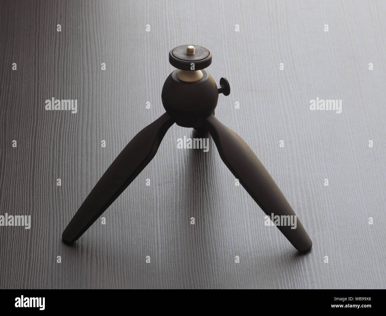 Compact tripod for cameras on the table. Stock Photo