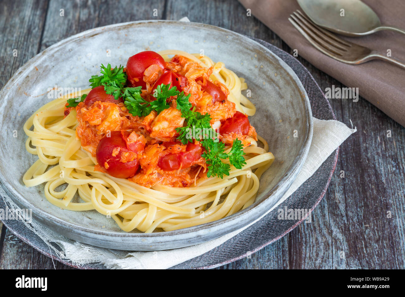 Chilli crab and cherry tomato linguine pasta Stock Photo - Alamy
