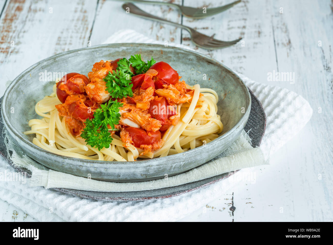 Chilli crab and cherry tomato linguine pasta Stock Photo - Alamy
