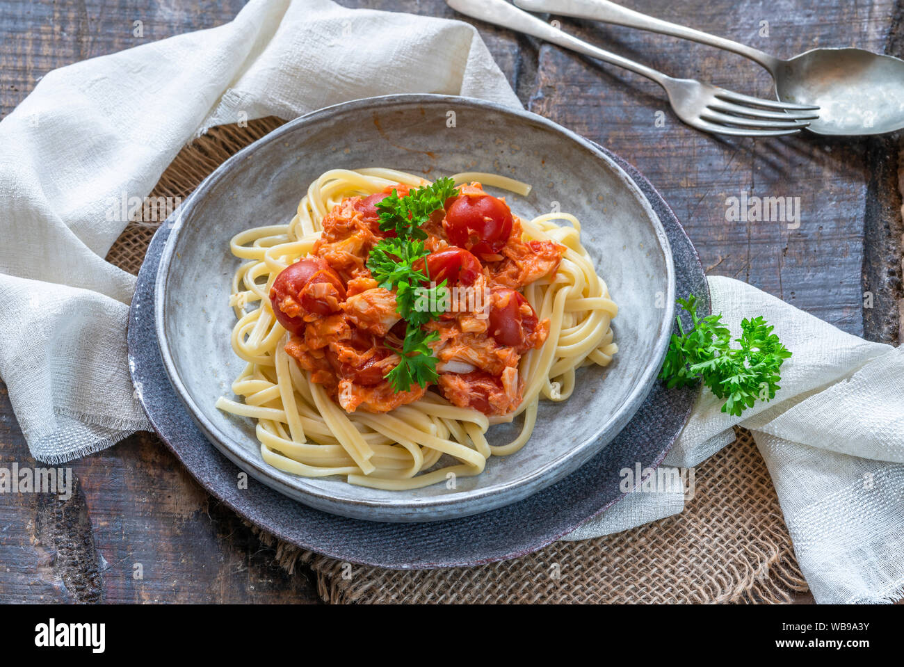 Chilli crab and cherry tomato linguine pasta Stock Photo - Alamy