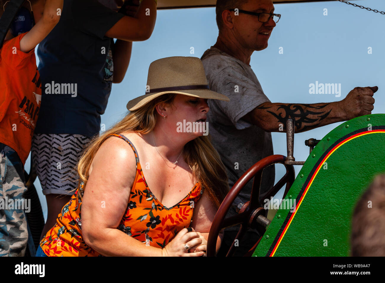 Woman steers a traction engine at the Hellingly Festival of Transport show. Stock Photo