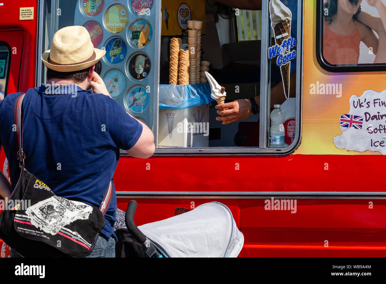 A man serves an Ice cream with a flake at the Hellingly Festival of Transport show. Stock Photo