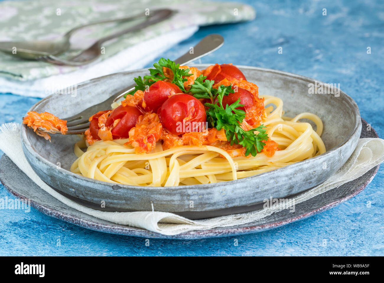 Chilli crab and cherry tomato linguine pasta Stock Photo - Alamy