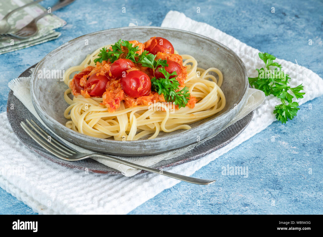Chilli crab and cherry tomato linguine pasta Stock Photo - Alamy