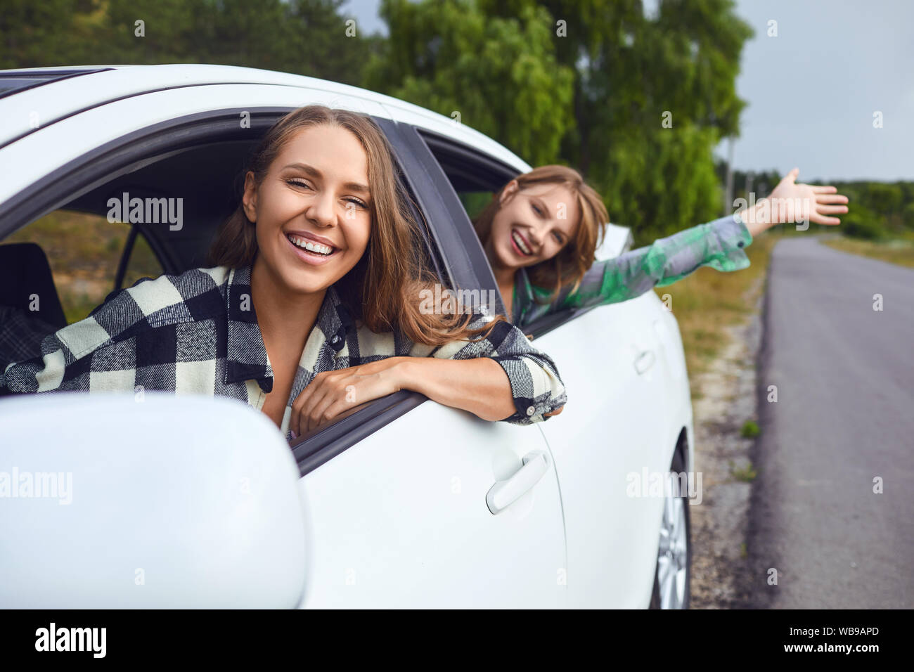 A group of happy friends are driving in a car Stock Photo - Alamy
