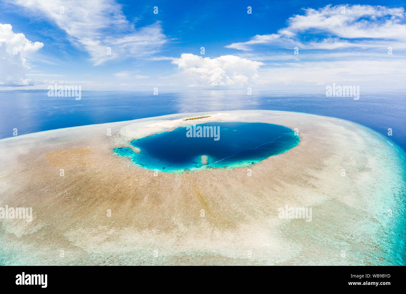 Aerial idyllic atoll, scenic travel destination Maldives Polinesia. Blue lagoon and turquoise coral reef. Shot in Wakatobi National Park, Indonesia Stock Photo