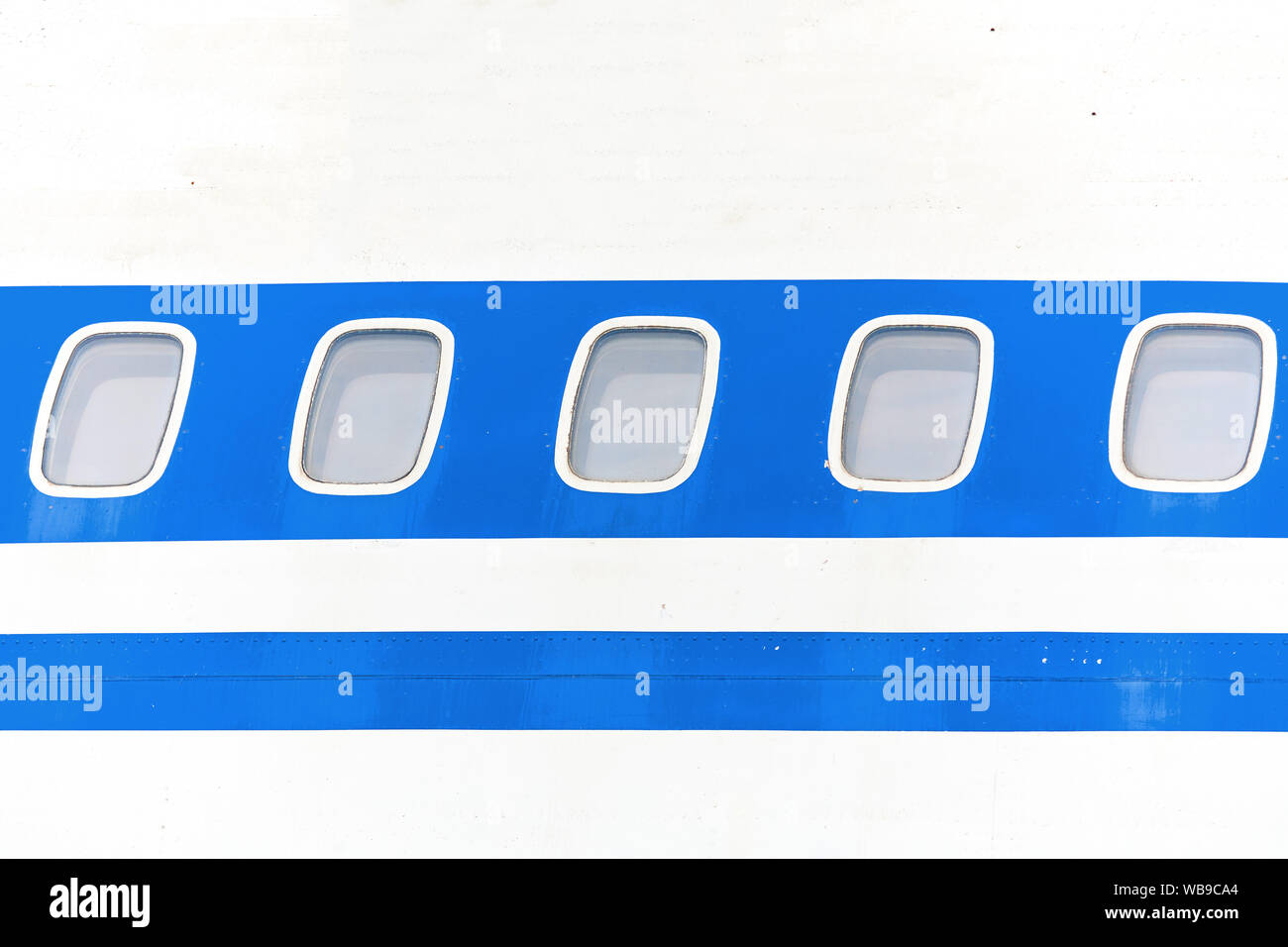 Elements of passenger aircraft with a blue stripe close-up. Stock Photo