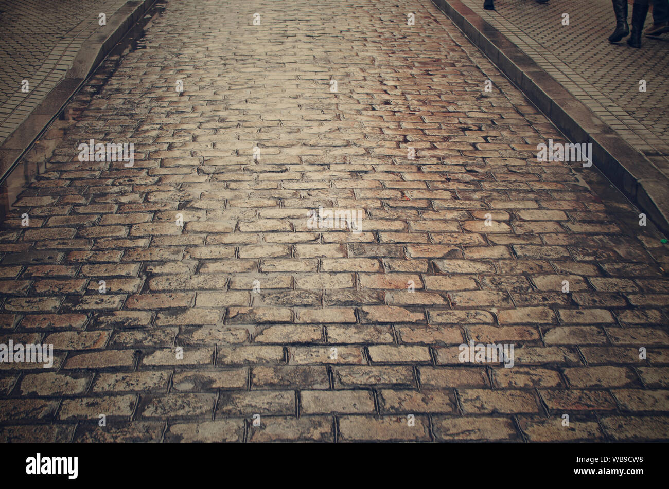 Closeup of a cobblestone street on a rainy day in Seville, Andalusia, Spain Stock Photo
