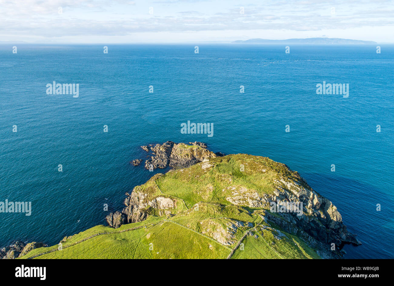 Torr Head headland, rocky cliff and peninsula in County Antrim, Northern Ireland, near Ballycastle. Aerial photo with far view of Scotland Stock Photo