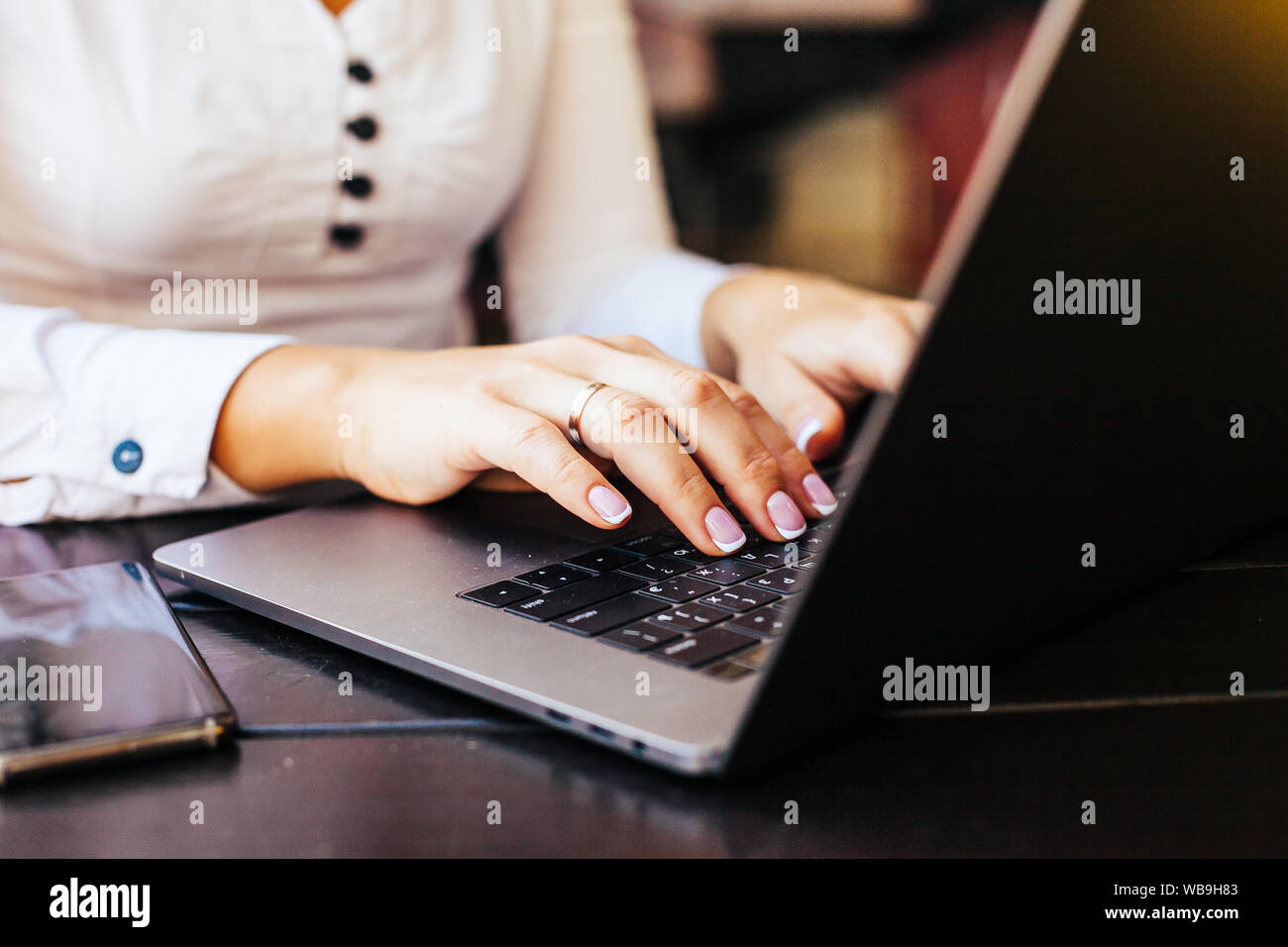 Close up shot of hands typing on laptop Stock Photo