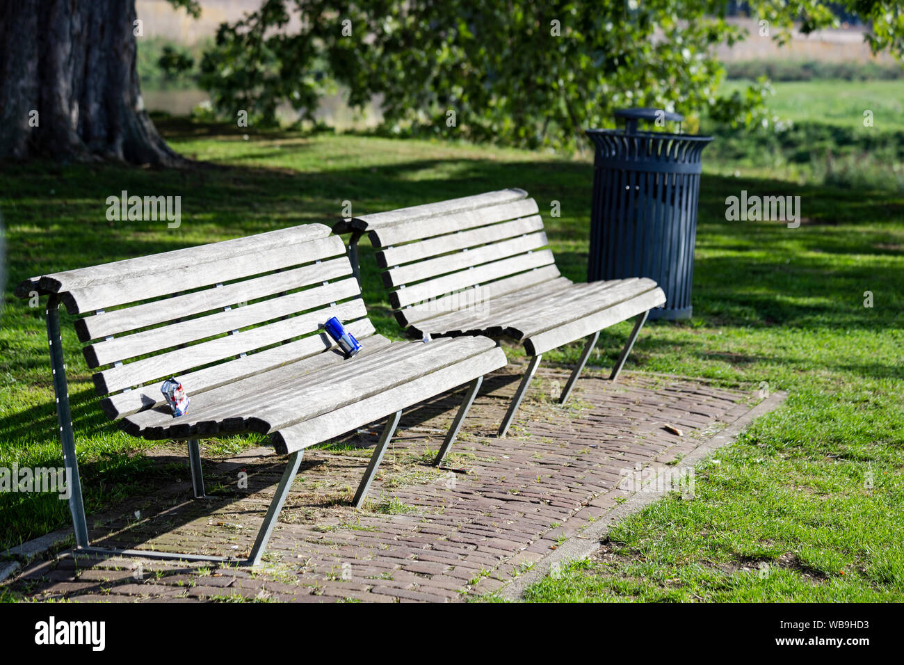 Used Plastic Left As A Garbage On A Wooden Bench In The Park