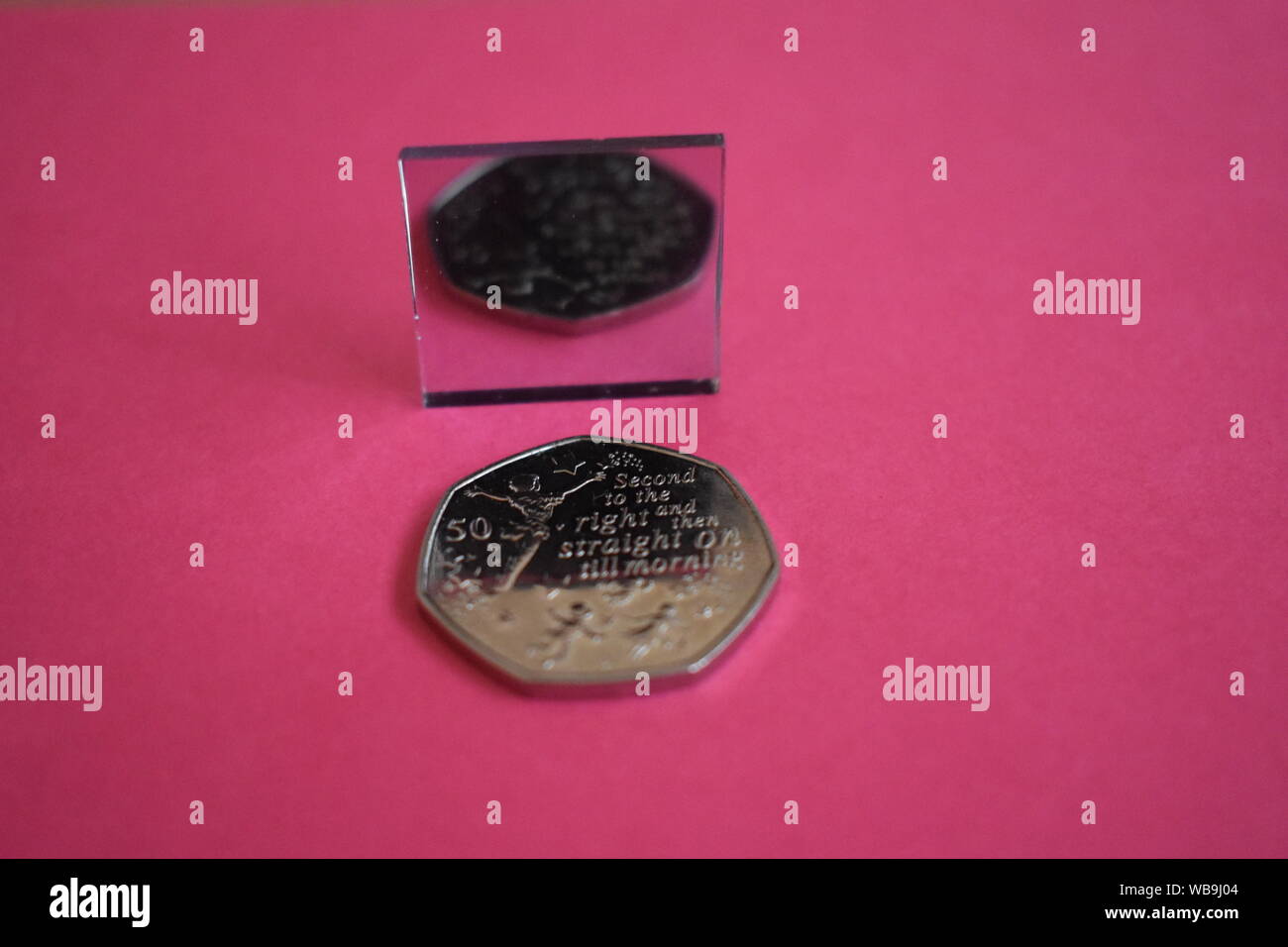 Peter Pan 50p with mirror reflection on colourful background Stock Photo