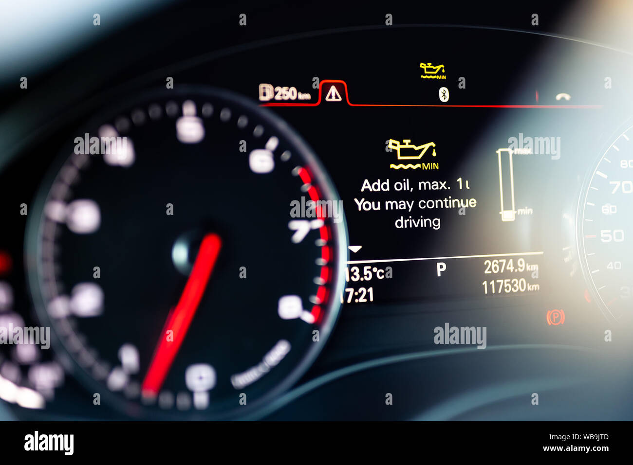 Luxury car color screen dashboard with warning message. Low engine oil