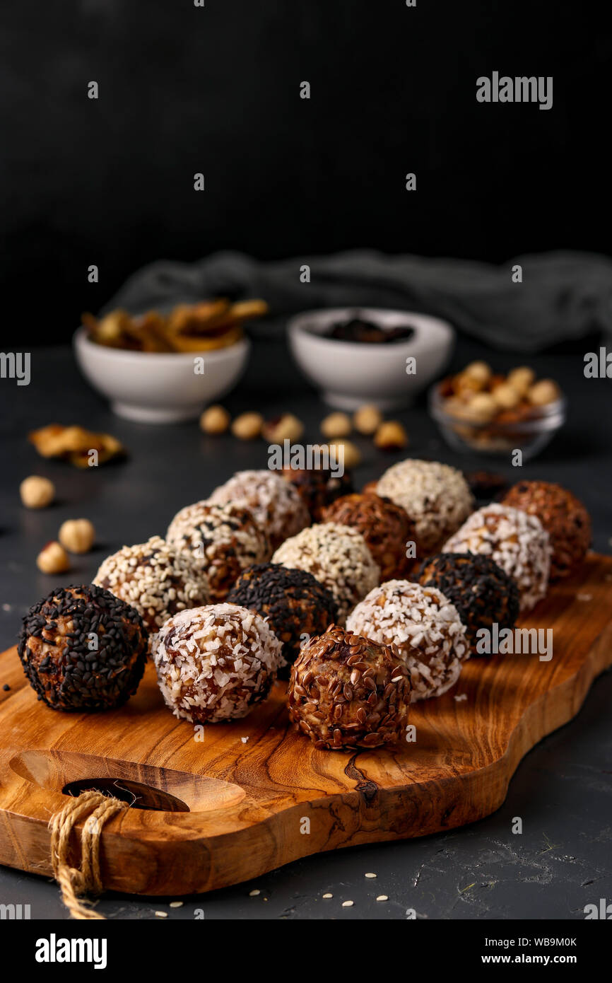 Energy balls of nuts, oatmeals and dried fruit in plate on dark