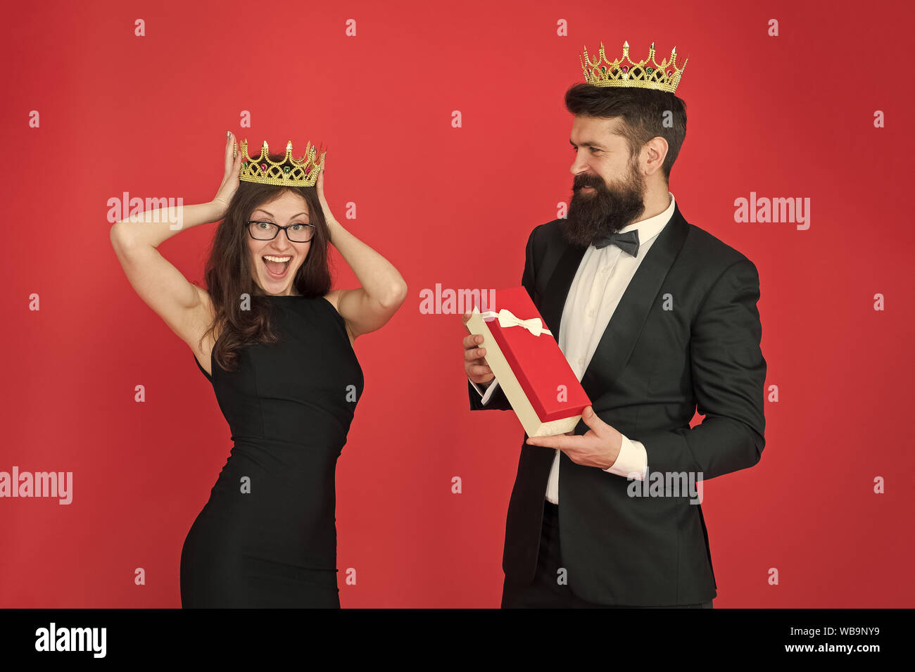 royal couple in love. date. business success. business fashion. anniversary party gift. Formal business couple. man in tuxedo and woman. Bearded man and happy woman in crown. Successful professional. Stock Photo