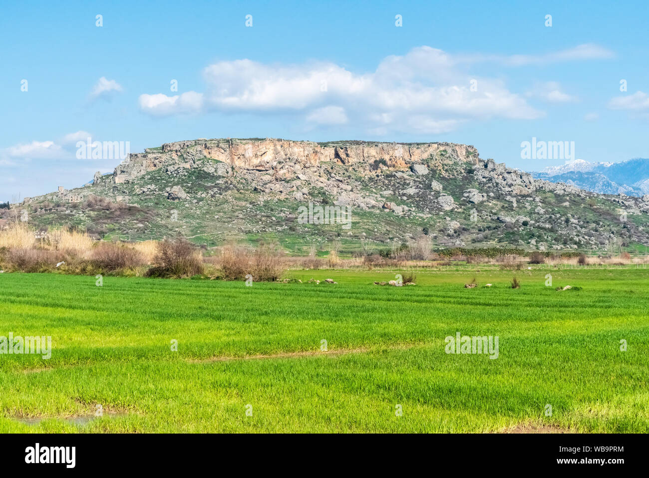 Rocky outcrop with the scattered ruins of Silyon ancient city in Antalya province of Turkey. Stock Photo