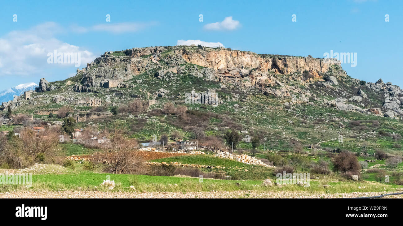 Rocky outcrop with the scattered ruins of Silyon ancient city in Antalya province of Turkey. Stock Photo