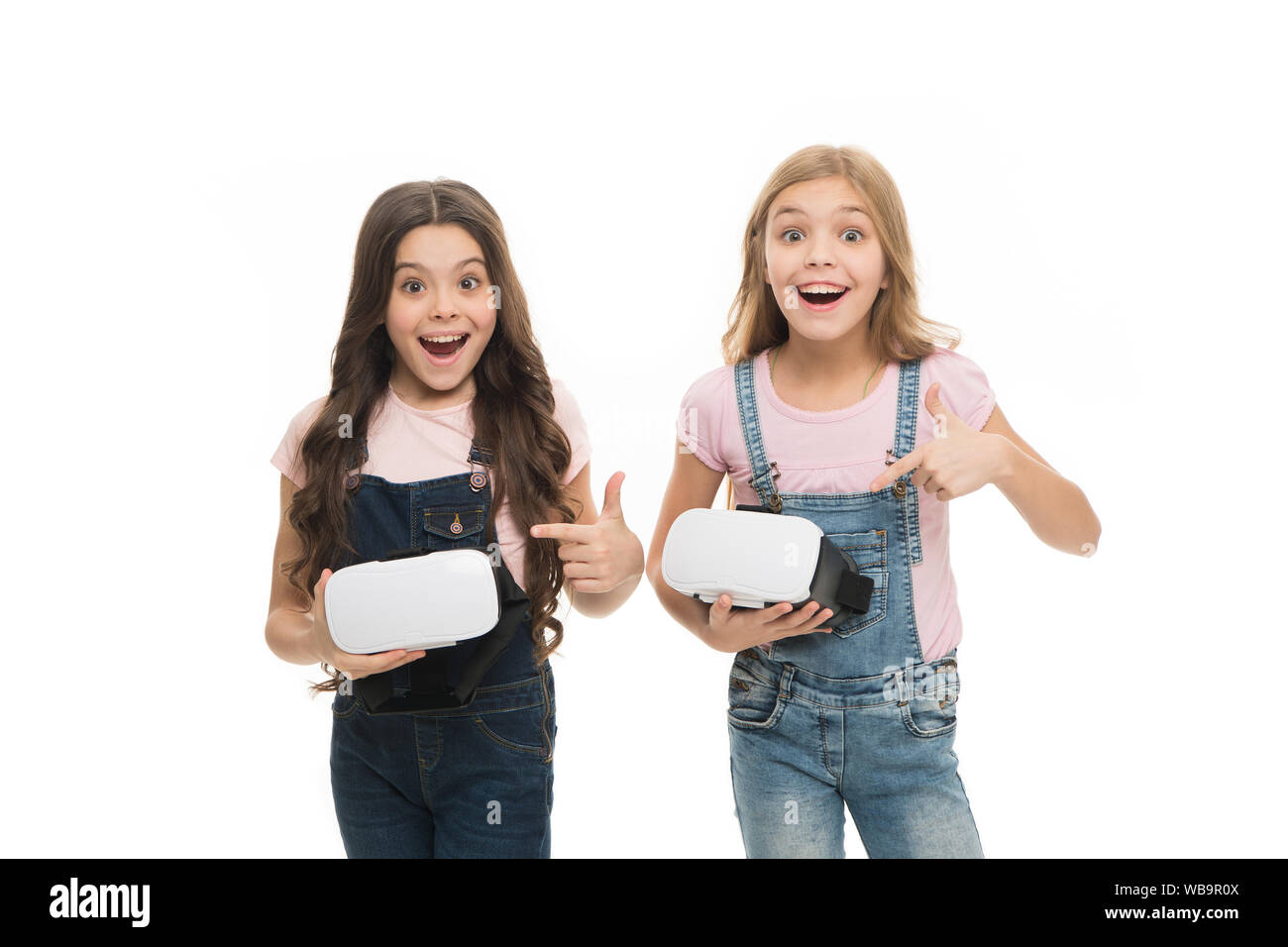 Cyber gaming. Augmented reality technology. Virtual reality is exciting. Girls little kids wear vr glasses white background. Virtual education concept. Modern life. Interaction in virtual space. Stock Photo