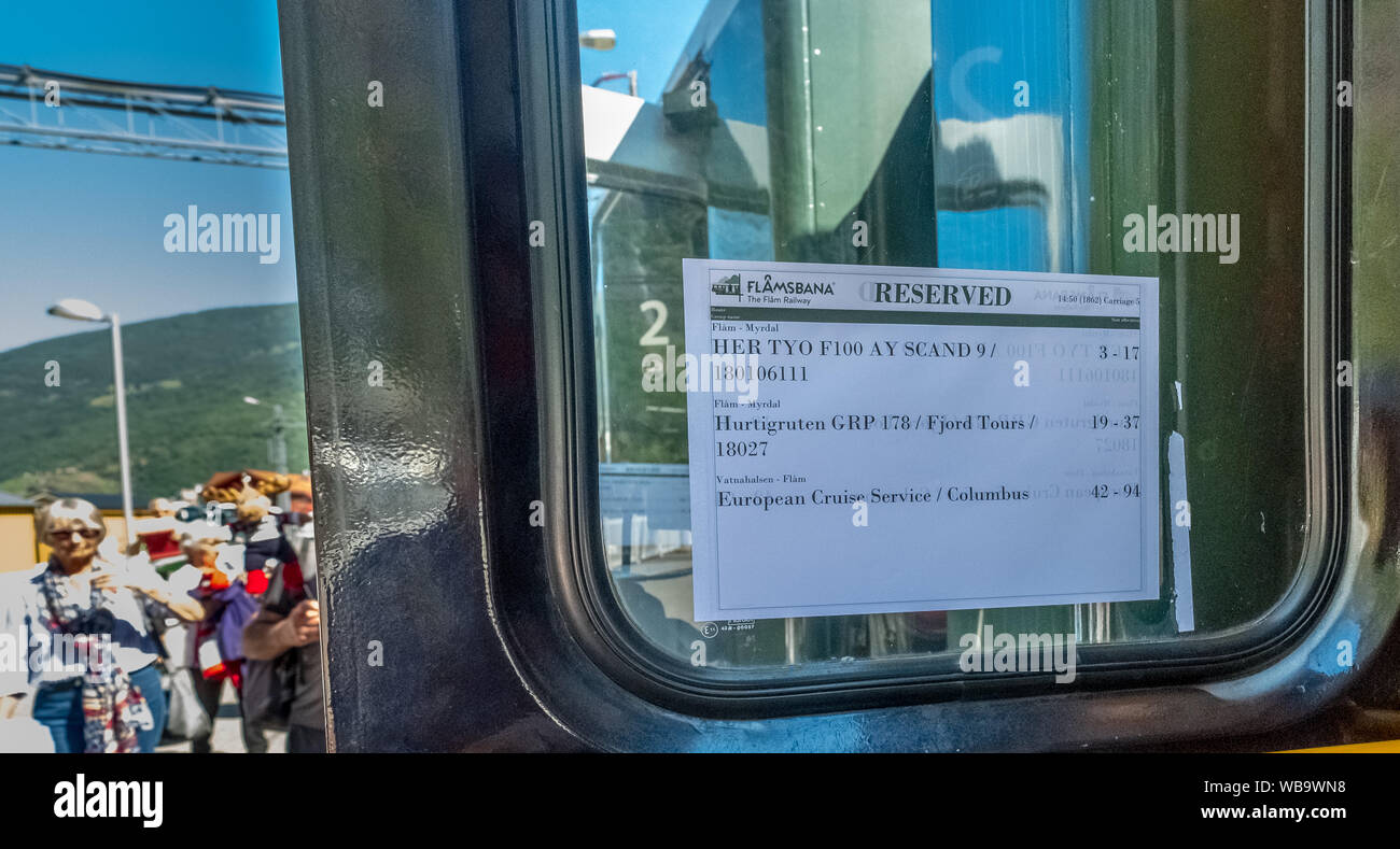 Travel with the Flambahn, iron bogie journey, information leaflet about reservations of the Flamsbahn, train windows, Flåm, Sogn og Fjordane, Norway, Stock Photo