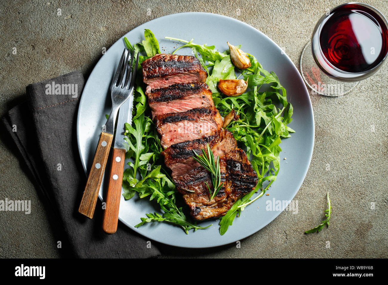 Grilled ribeye beef steak with red wine, herbs and spices. Top view ...