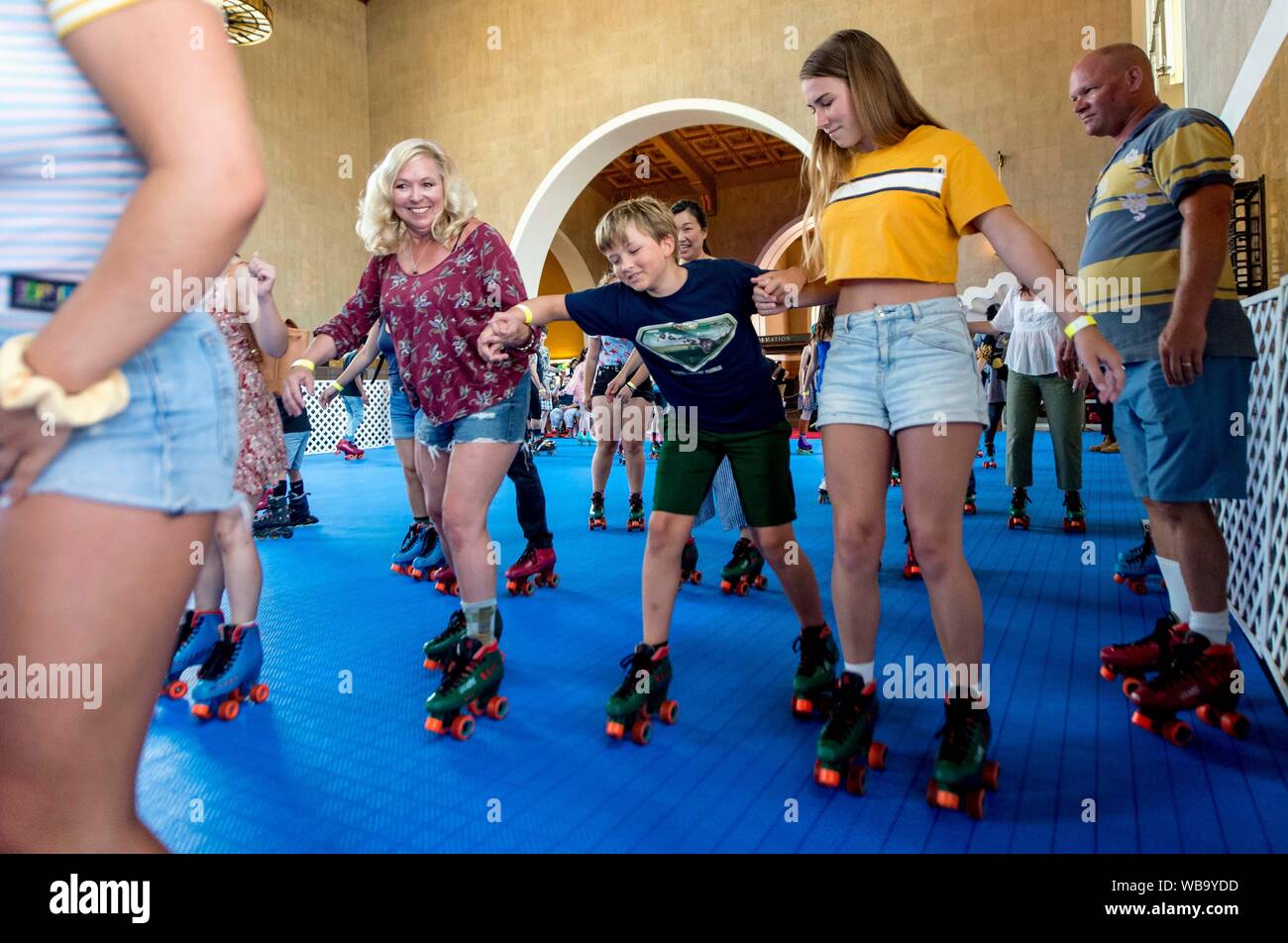 Los Angeles, California, USA. 25th Aug, 2019. A custom-built, pop-up roller rink constructed in historic Union Station's ticket concourse attracts Angelenos for a weekend of roller skating to music from the disco era. Credit: Brian Cahn/ZUMA Wire/Alamy Live News Stock Photo