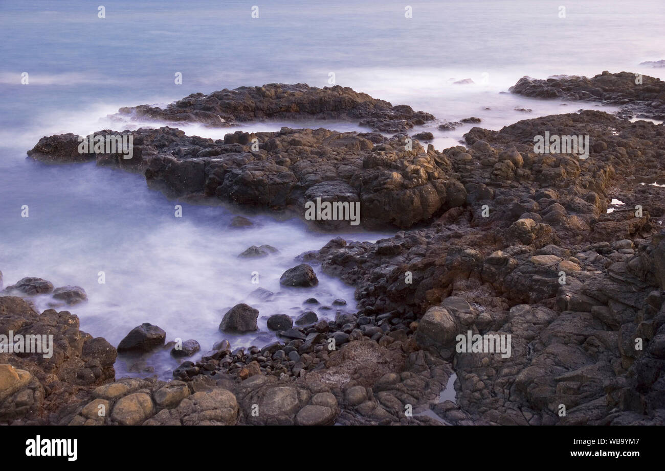 Barolin Rocks. Deceptively barren rocky shores such as these house a wide diversity of marine invertebrates that provide valuable feeding areas for fi Stock Photo
