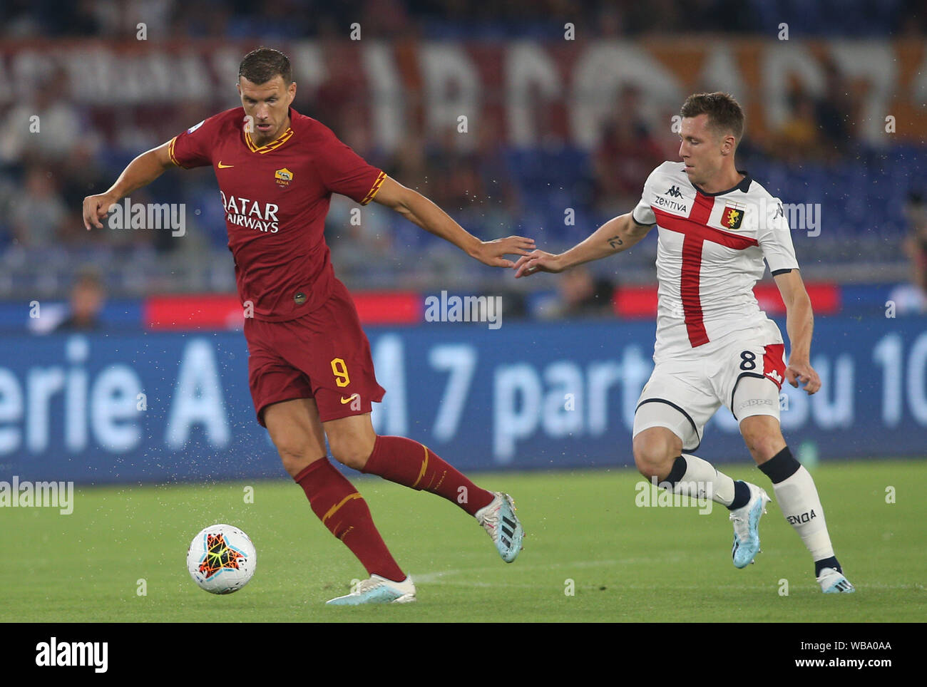 Rome, Italy. 26th Aug, 2019. Rome, Italy - August 25, 2019: Edin Dzeko (AS ROMA) AND L.Lerager (GENOA) in action during the Serie A soccer match between AS ROMA and GENOA FC, at Olympic Stadium in Rome. Credit: Independent Photo Agency/Alamy Live News Stock Photo