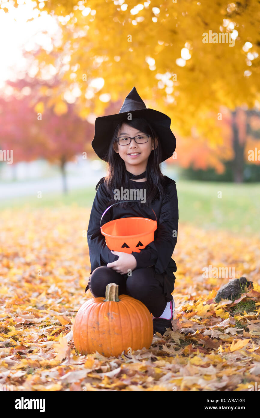 Portrait of little asian girl in witch costume Stock Photo - Alamy
