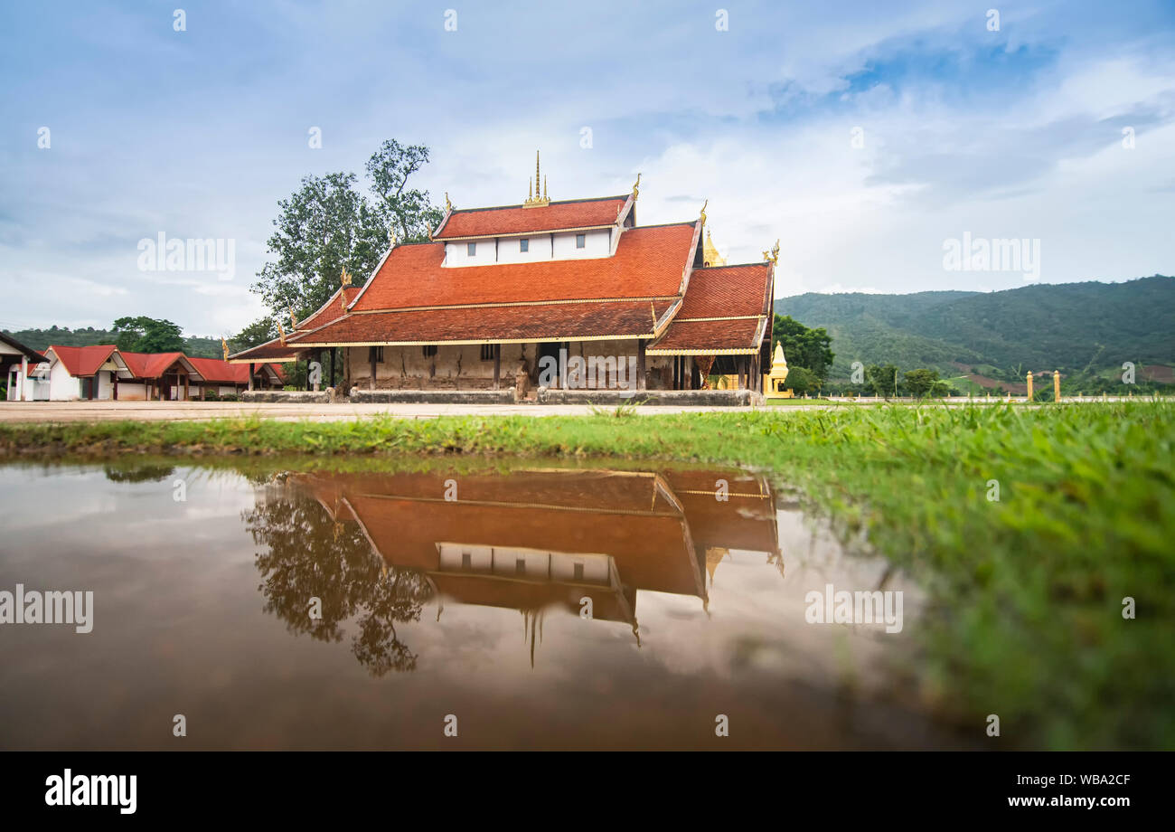 Old temple in Thailand Reflect water / The story ancient temple of is over 400 years old landmark of buddhist - Wat Sri Pho Chai at Na Haeo Loei Thail Stock Photo