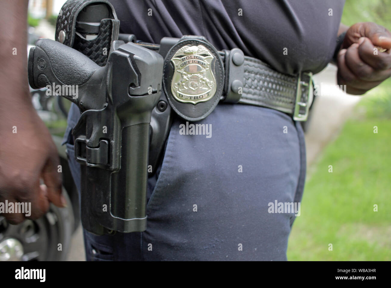 Gun and badge on cop’s belt, Detroit, Michigan, USA Stock Photo
