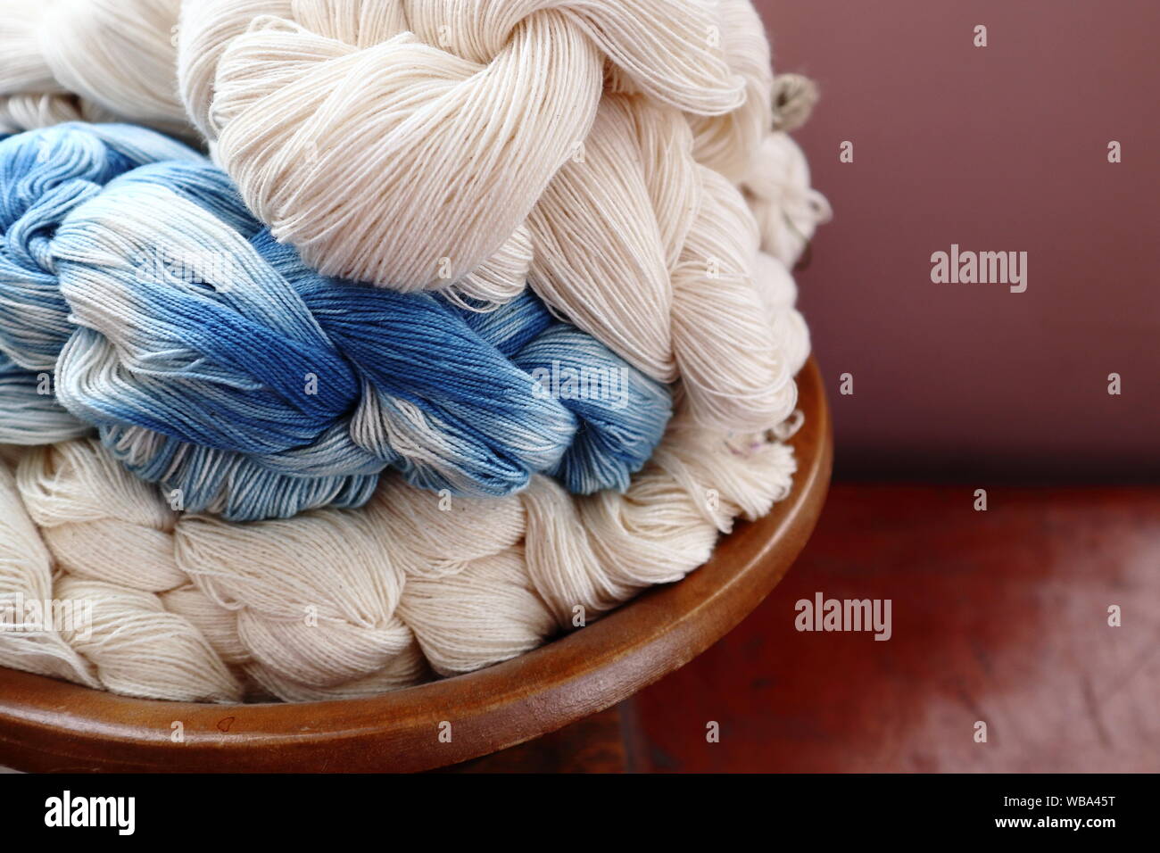 cotton warp chains in natural undyed and indigo hand dyed yarn Stock Photo
