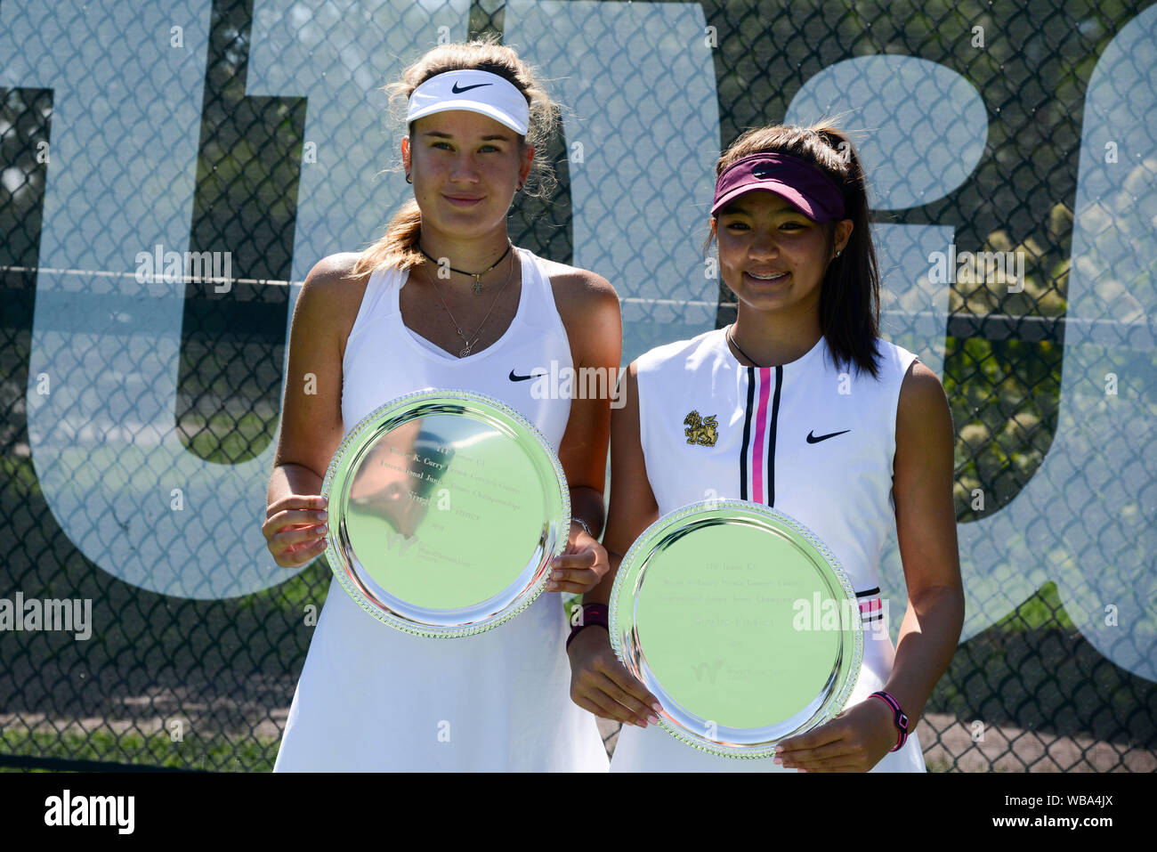 College Park, Maryland, USA. 24th Aug, 2019. Kamilla Bartone of Latvia and  Mai Napatt Nirundorn of Thailand pose with their trophies after the singles  final in the Wayne K. Curry Prince George's