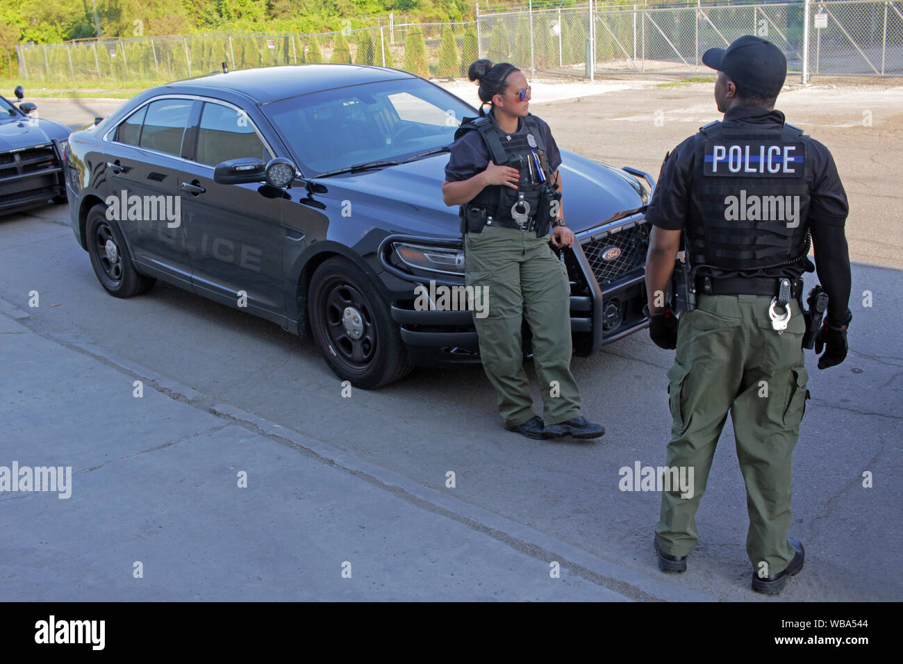Detroit Special Operations police officers stand by their cars, Detroit