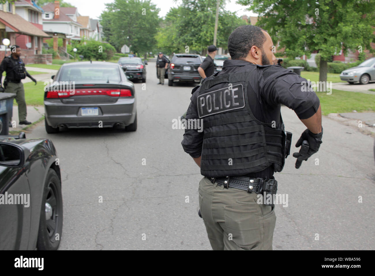 Detroit Police Department Special Operations officer drawers his gun as