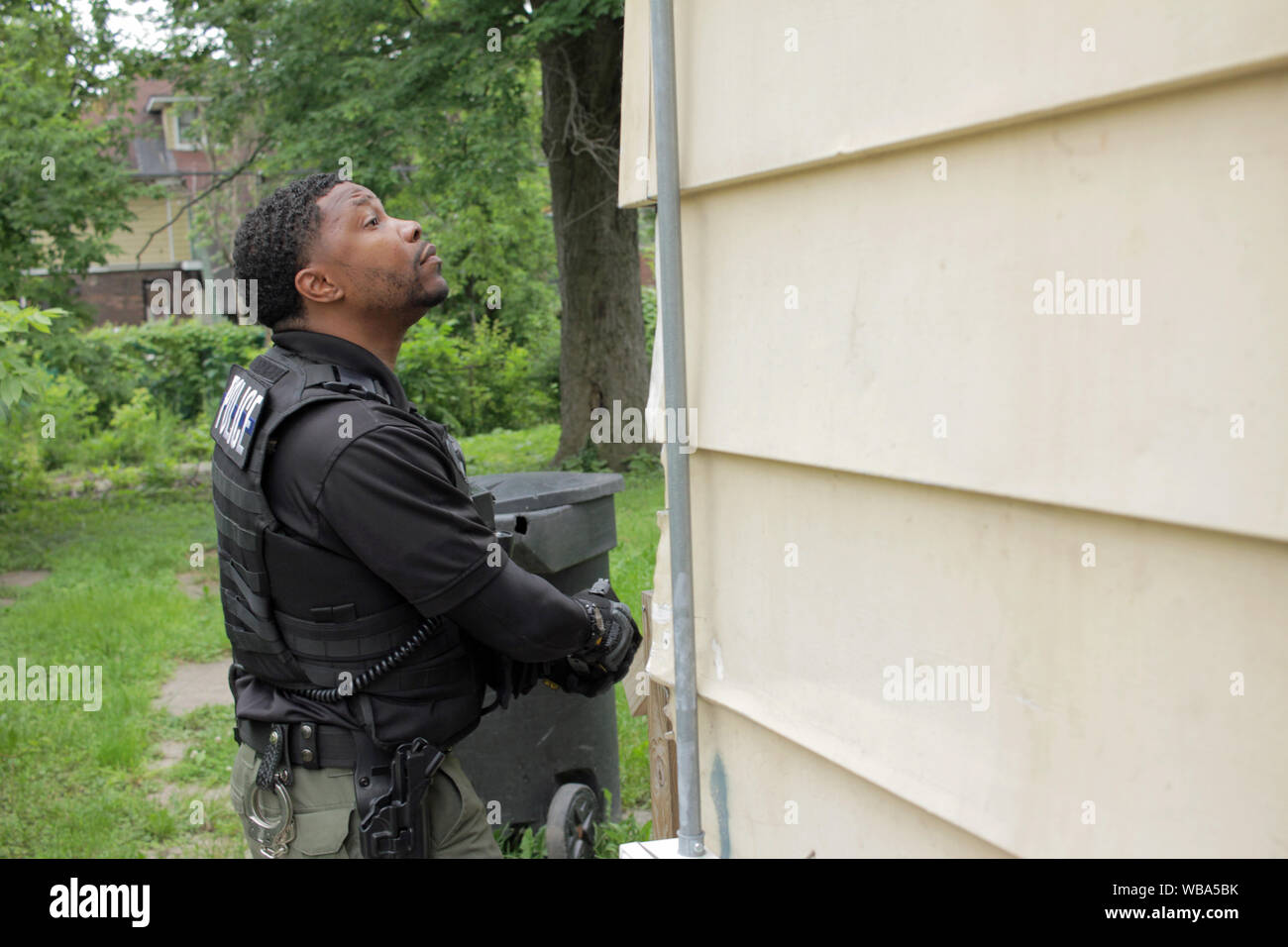 Detroit Special Ops police officer searches for a wanted suspect