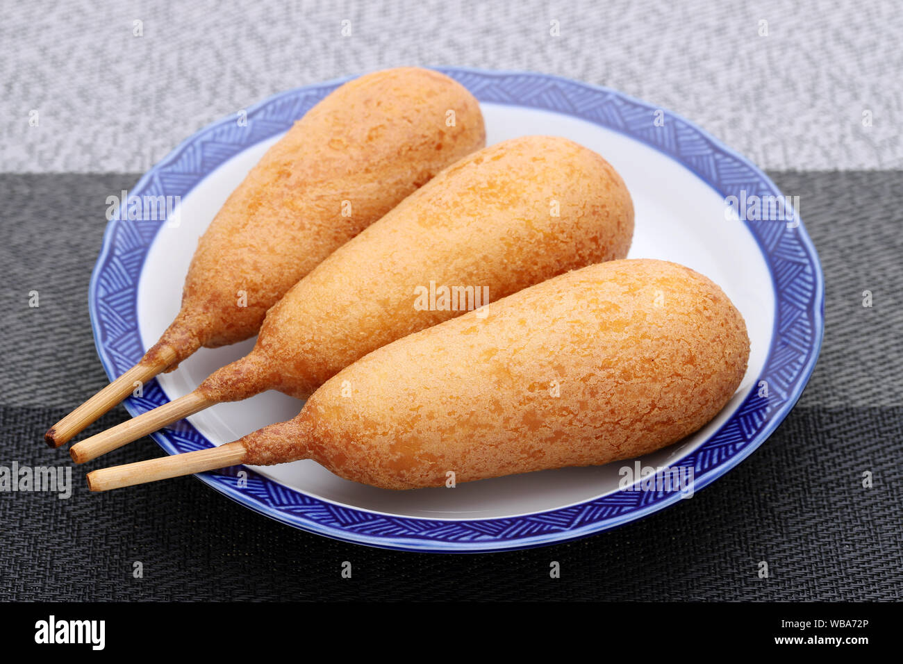 Corn dogs on a plate. This food is called American dog all over Japan. Stock Photo