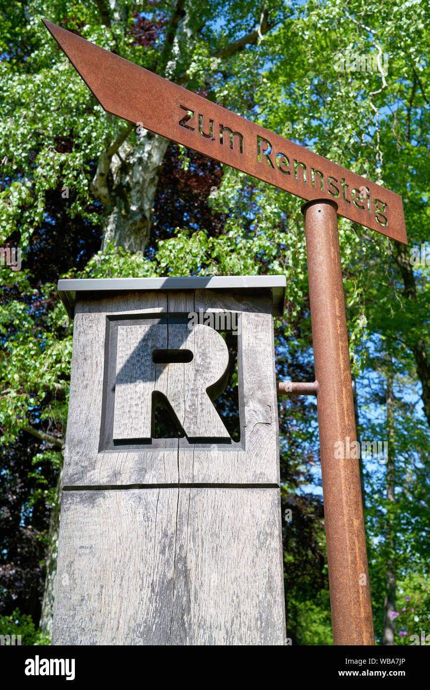 Signpost to the hiking trail 'Rennsteig' in Thuringia in Germany. The popular hiking trail is about 169 kilometers long. Stock Photo