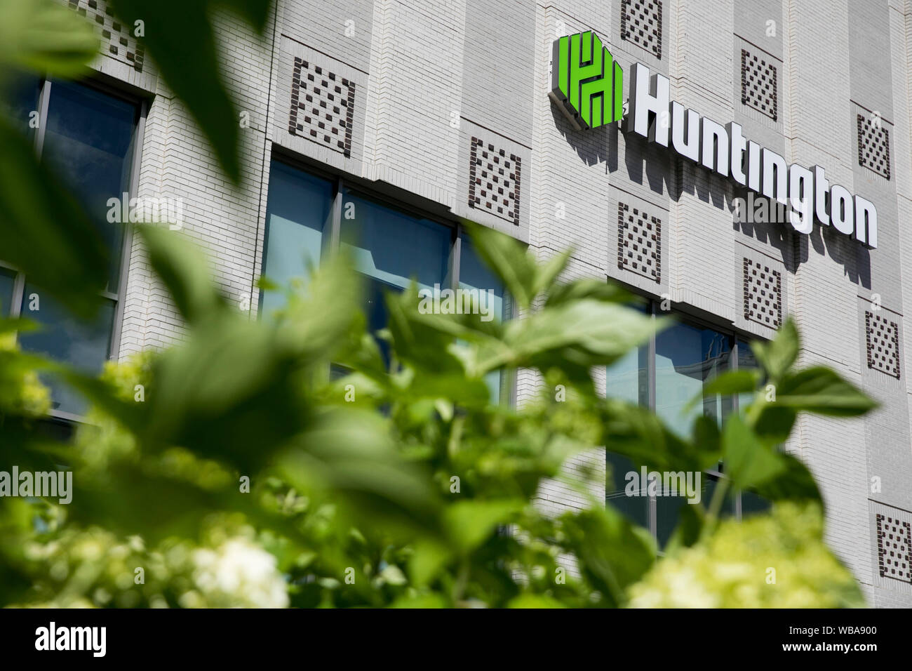 A logo sign outside of a facility occupied by Huntington Bank in Akron