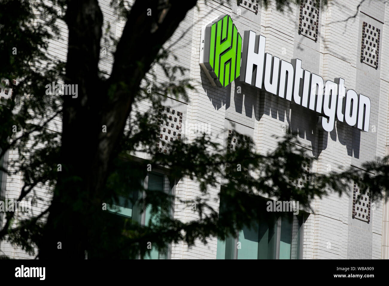 A logo sign outside of a facility occupied by Huntington Bank in Akron