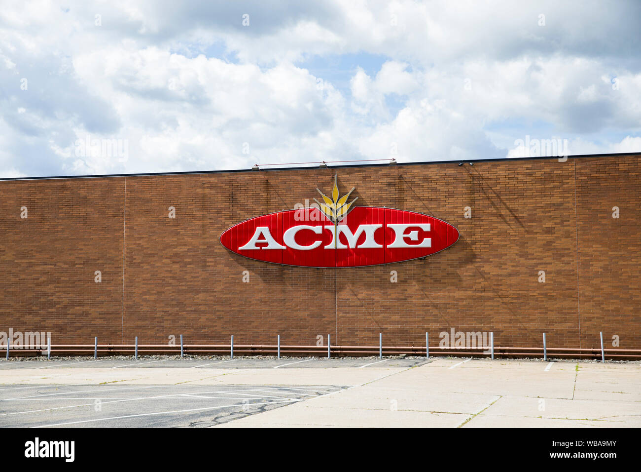 A logo sign outside of the headquarters of Acme Fresh Market in Akron