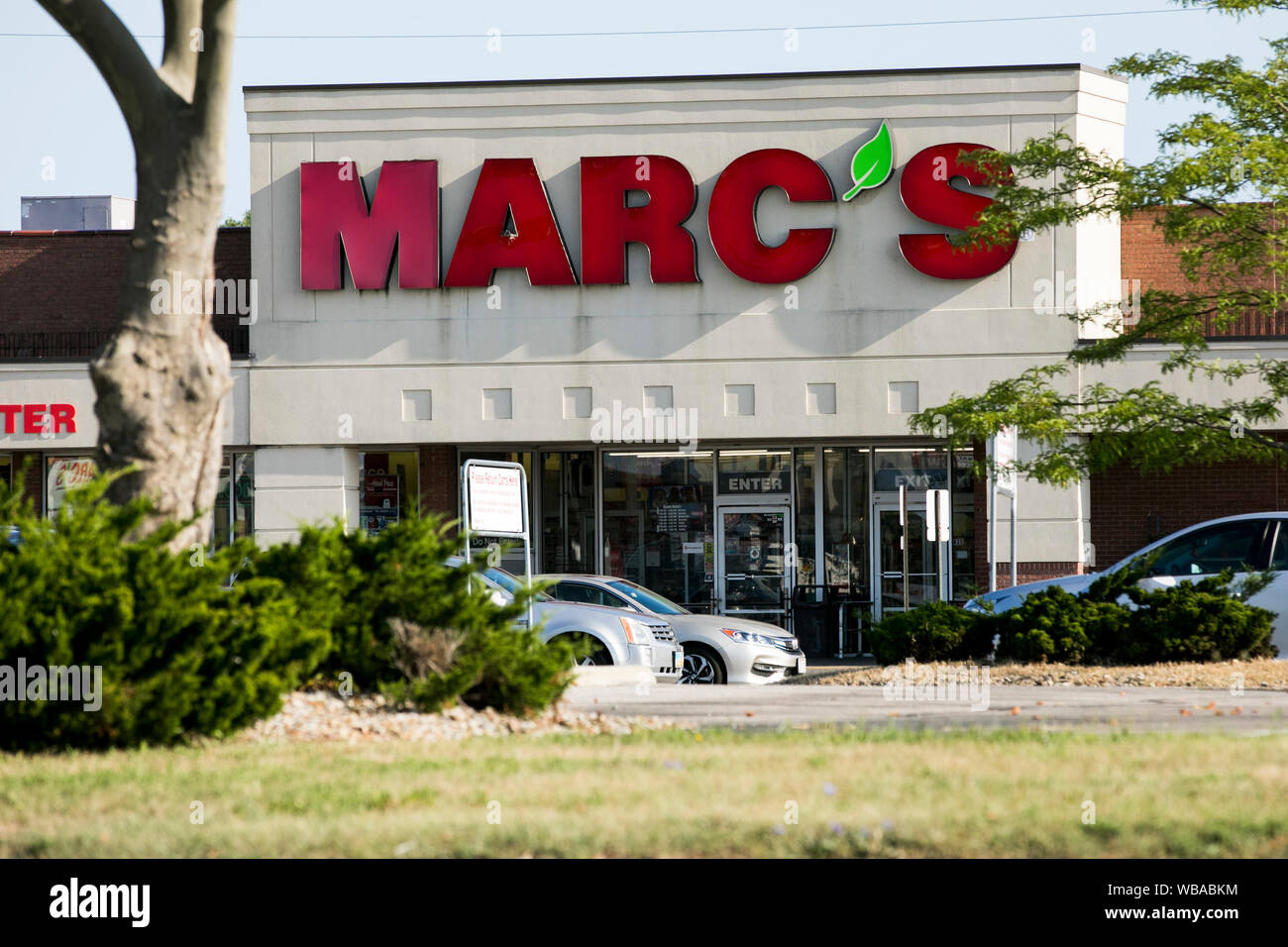 A logo sign outside of a Marc's Stores retail grocery store location in