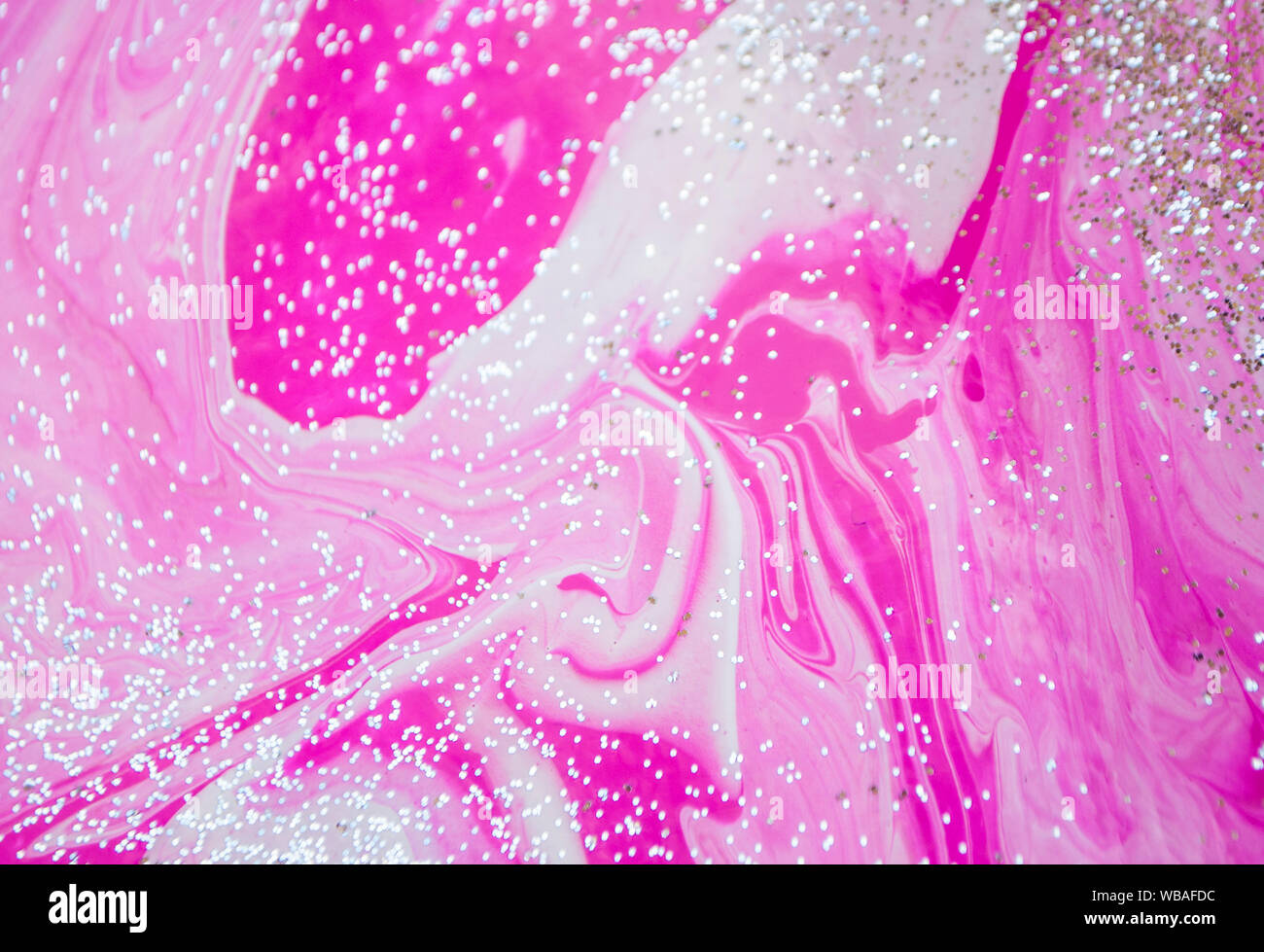 Abstract colorful painting background made in fluid art technique. Fluid art pattern in trendy colors with glitter. Stock Photo