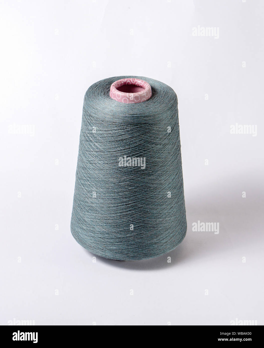 bobbin of yarn on a white background. Side view.Textile reel on