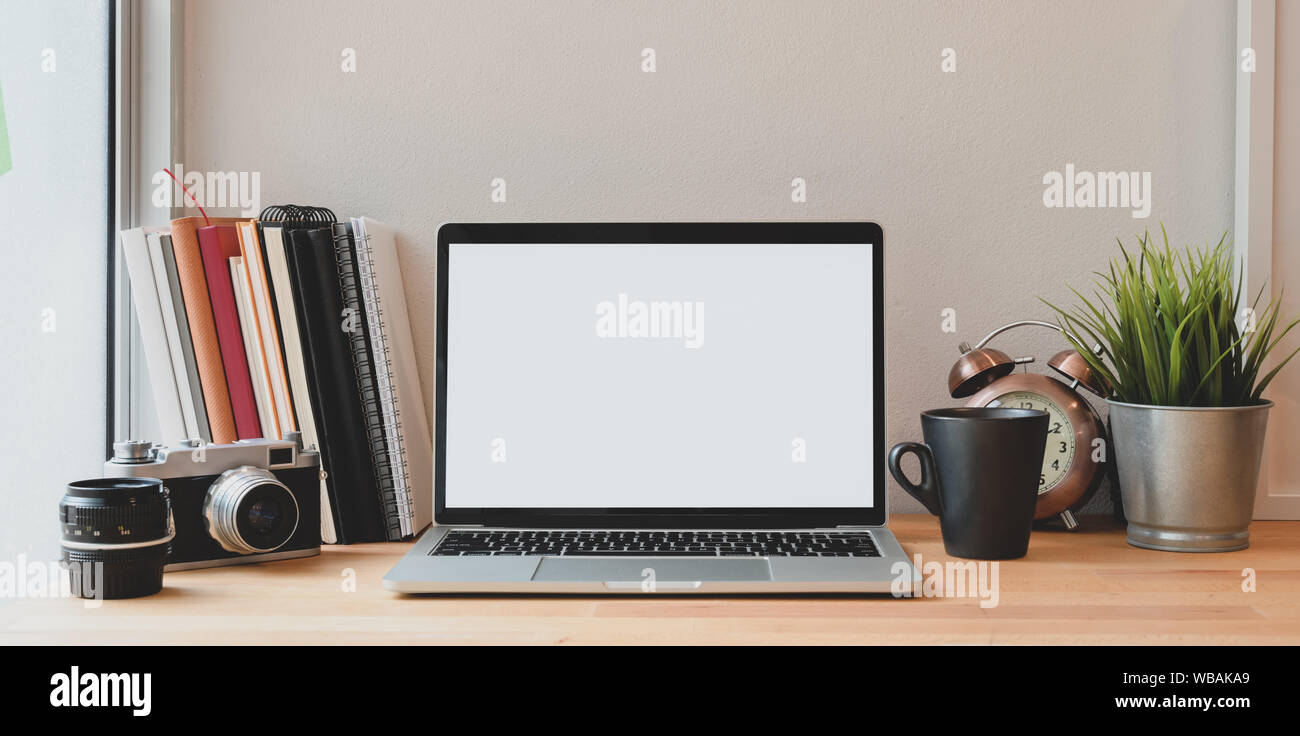 Open blank screen laptop computer in minimal photographer's workplace ...