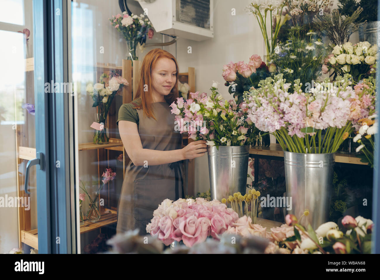 Young flower shop worker checking flowers Stock Photo Alamy