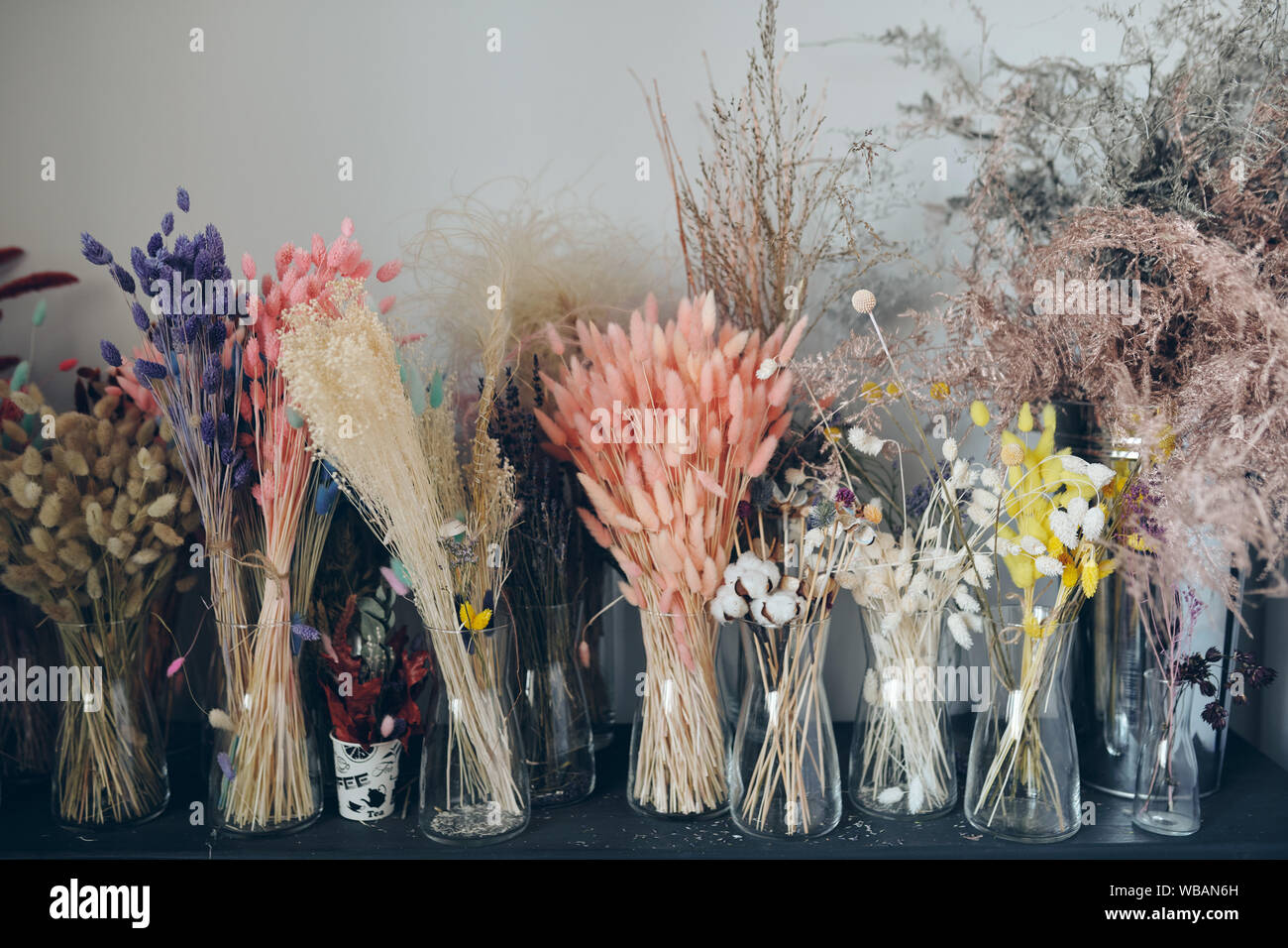 Colorful dried flowers on shelf Stock Photo Alamy