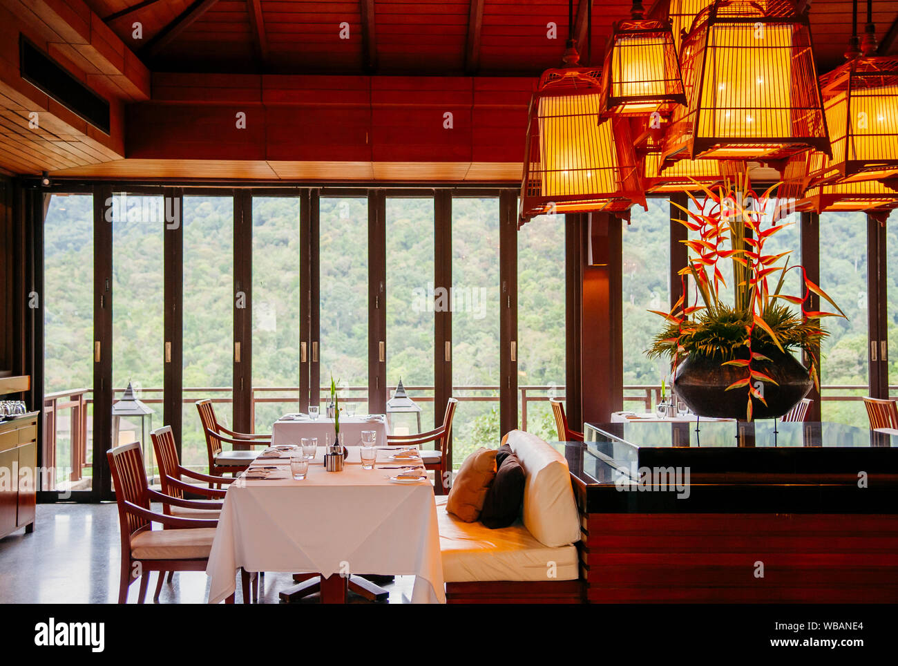MAY 17, 2014 Krabi, THAILAND - Asian luxury style hotel restaurant with contemporary wooden furnitures, chairs, tables , bird cage pedant lamps decora Stock Photo