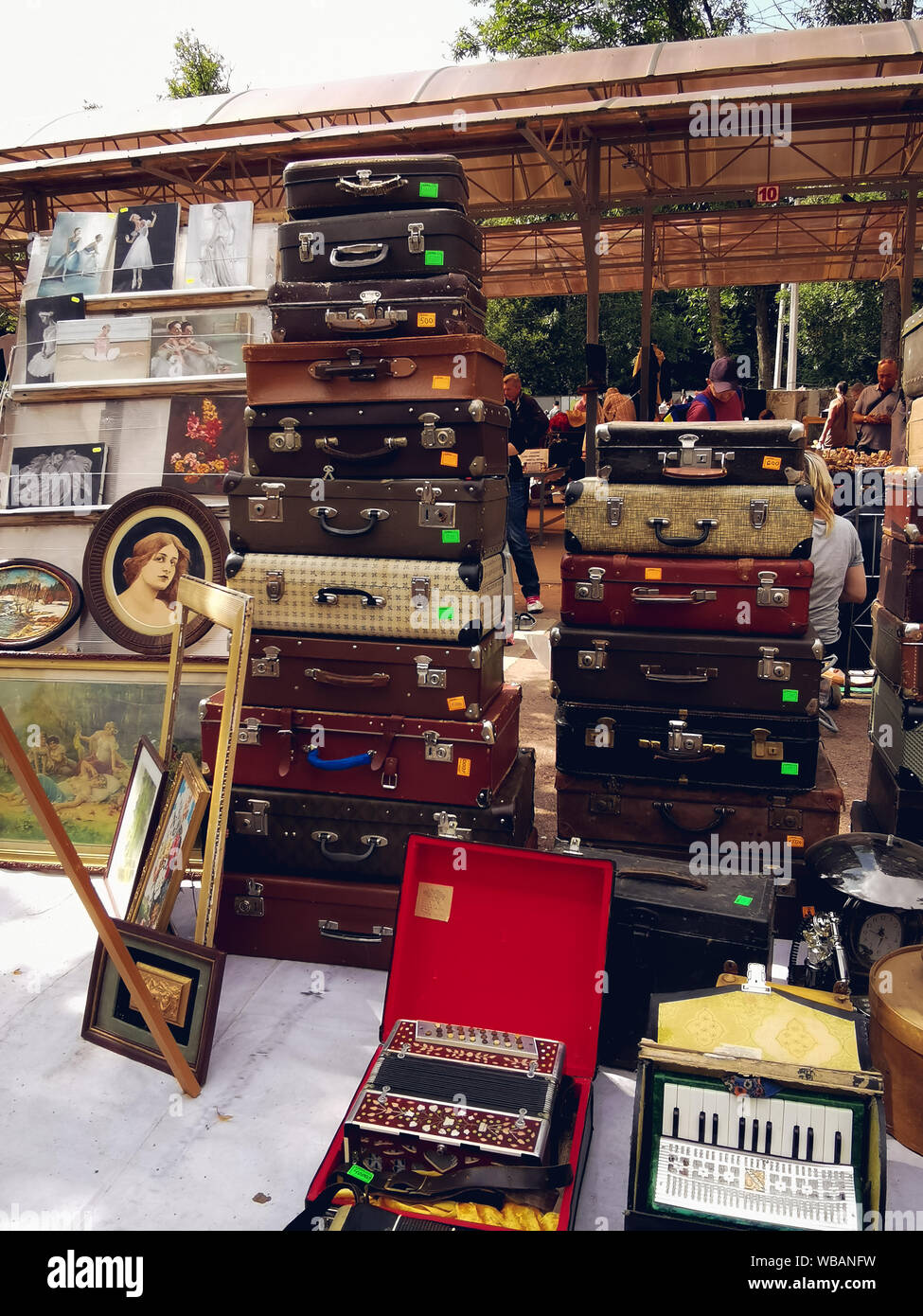 Saint-Petersburg, Russia - 22 August 2019: many old suitcases,paintings and accordions are sold at the flea market. Stock Photo